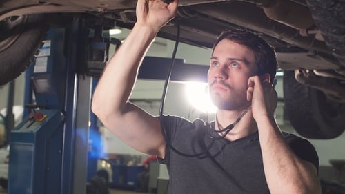 Mechanic Listen Engine with Stethoscope in Repair Garage.
