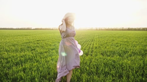 Beauty Girl Running on Spring Field with Colorful Air Balloons