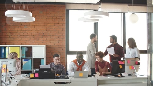 Multinational Young Office Workers in Casual Clothes Are Cooperating Together Indoors.