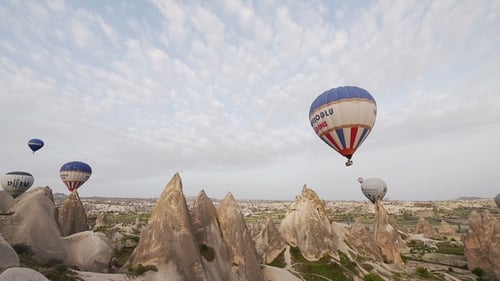 Hot Air Balloons Flying Over Cappadocia's Rock Formations