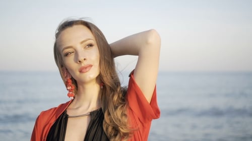 Portrait of Beautiful Girl on Beach at Sunset