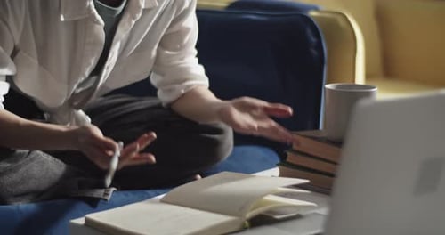 Young Adult Talks on Laptop in Casual Setting
