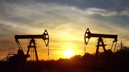 Oil Pump Jacks Silhouetted at Sunrise