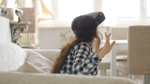 Woman Experiencing Virtual Reality Headset at Home
