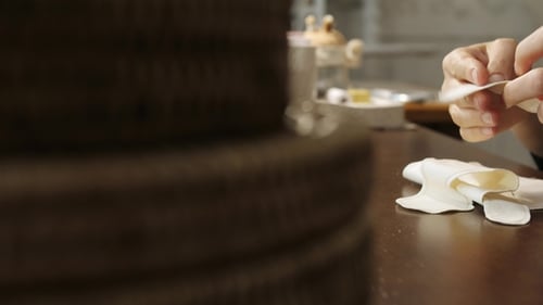 Womans Hand Is Working with Sewing Patterns on a Studio Table.
