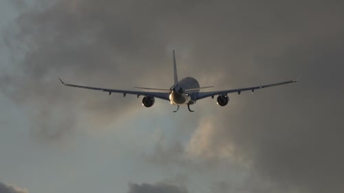 Commercial Airplane Ascending Into Cloudy Sky