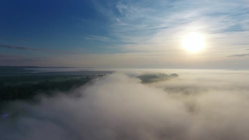 Aerial View of Fog Shrouded Landscape at Sunrise