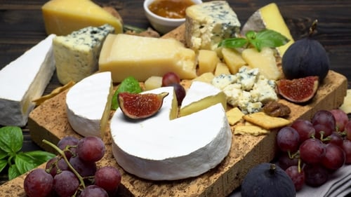 Appetizing Cheese Board with Fruits and Garnishes