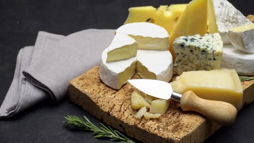 Delicious Cheese Variety on Wooden Board Still Life