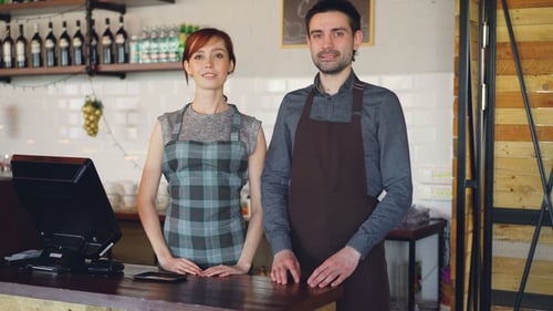 Cafe Staff Smiling Behind Counter in Restaurant