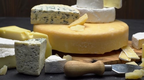 Various Cheeses Displayed on a Wooden Board