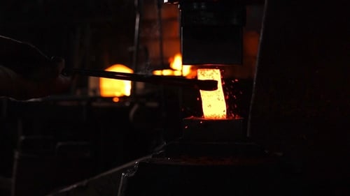 Blacksmith Shaping Red Hot Metal with Press