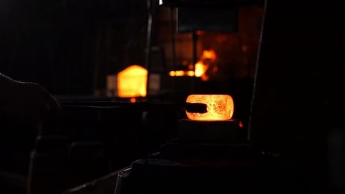 Blacksmith Forging Glowing Metal with a Machine Press