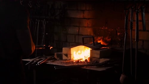 Blacksmith Working at a Fiery Forge in Workshop