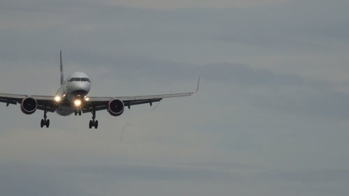 Plane Flying Through the Sky for Landing