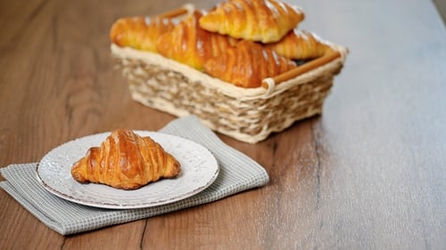 Fresh Croissant and Coffee on a Wooden Table