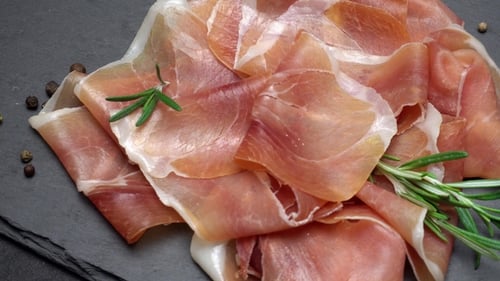 Tranches de prosciutto ou de jamon sur fond de béton