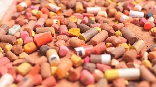 Multi-colored Chalk on a Gray Background . Side View.