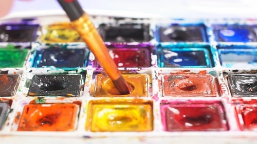 Paint Brush Dipping in Watercolor Palette