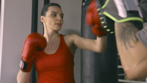 Woman Training with Coach in Boxing Club