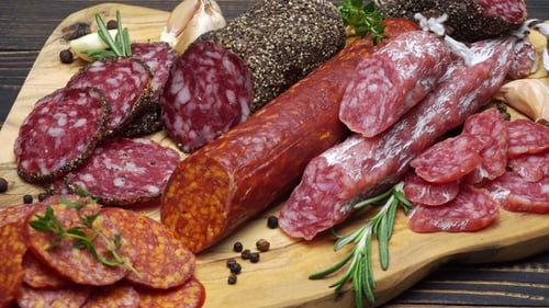 Assortment of Delicious Sausages on Cutting Board