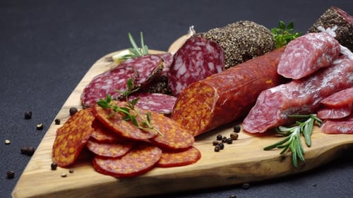 Salami and Chorizo Sausage on Dark Concrete Background