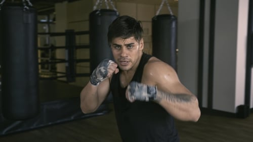 Male Boxer Shadowboxing in Gym