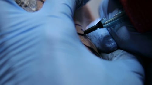 Professional Tattooist Doing Tattooing in Studio.