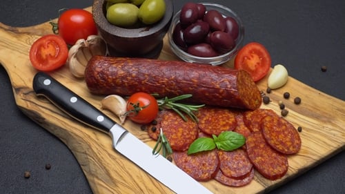 Pepperoni Sausage with Olives and Tomatoes on Board