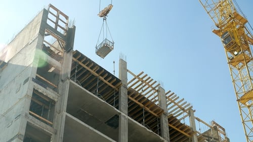 Construction Crane Working by Tower Building