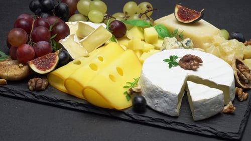 Delicious Cheese Selection with Grapes and Figs
