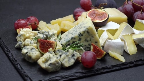 Delicious Assortment of Cheese, Figs, and Grapes