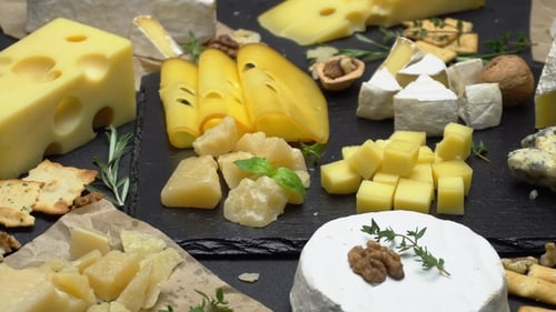 Assortment of Delicious Cheeses on Slate Board