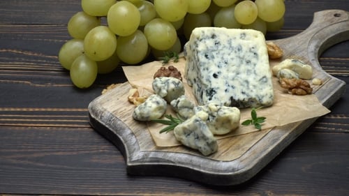 Grapes and Blue Cheese on Wooden Cutting Board