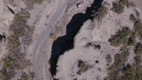 Aerial view looking down at dry wash in the desert