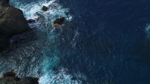 Waves Crashing on Rocky Coastline from Above