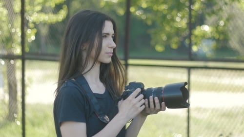 Portrait of Woman Photographer Taking Photos in Park