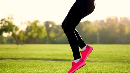 Woman Exercising Outdoors in a Park on Sunny Day