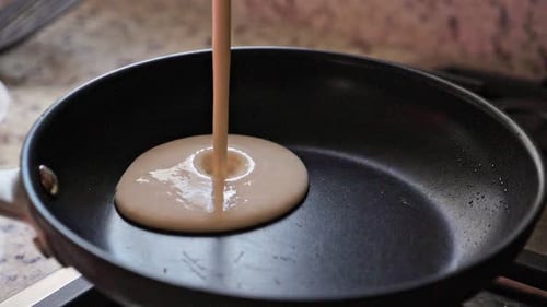Pouring Pancake Batter into Hot Frying Pan