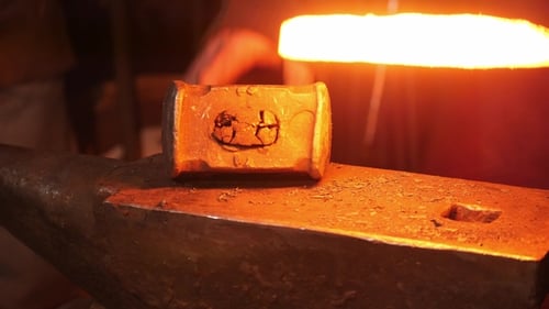 Hot Metal Worked on Anvil with Sparks