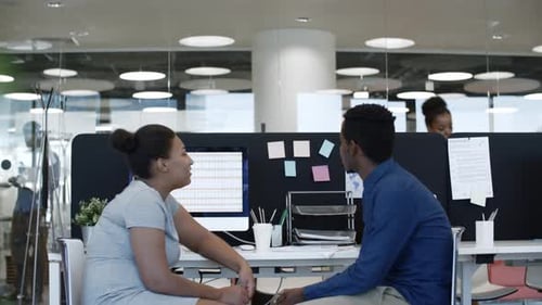 African Colleagues Speaking in Modern Office