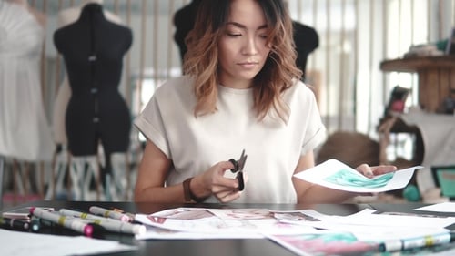 Fashion Designer Makes a Collage of Drawings. Girl Designer Clothes Makes Sketches on Paper. Young