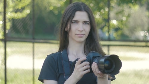 Portrait of Woman Photographer Taking Photos in Park