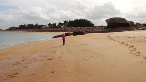 Child Girl Walking and Playing on an Empty Beach
