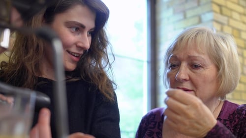 Two Women Chatting near Beverage Machine