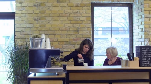 Barista and Mature Woman Intern Make Coffee on the Bar in Cafe
