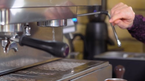 Barista Brewing Espresso with an Espresso Machine