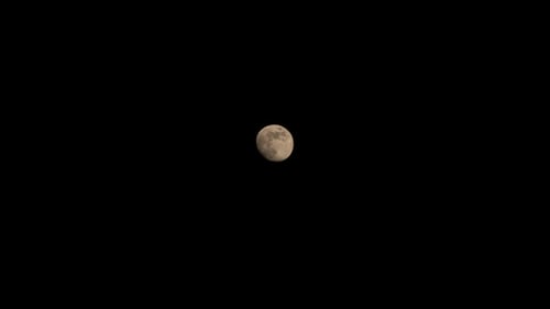 Zoom In on the Glowing Moon in Night Sky