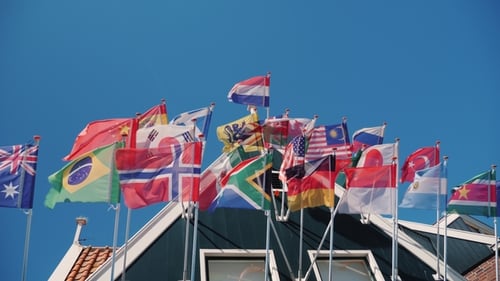 Various International Flags Waving on Building Roof
