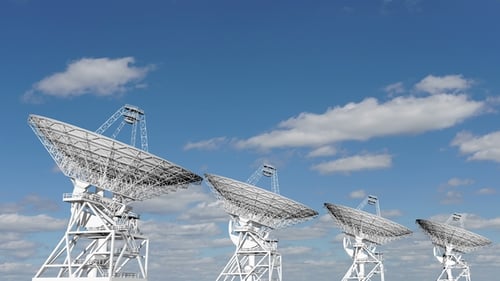 Animated Satellite Dishes Rotating in Blue Sky